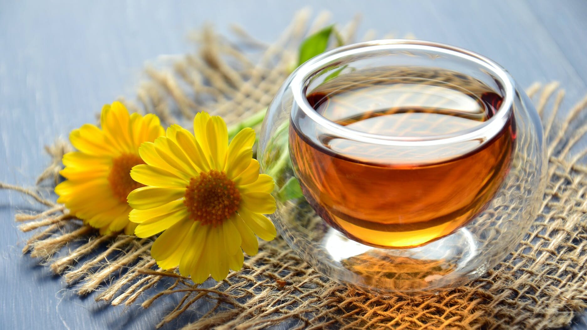 clear glass bowl beside yellow flower