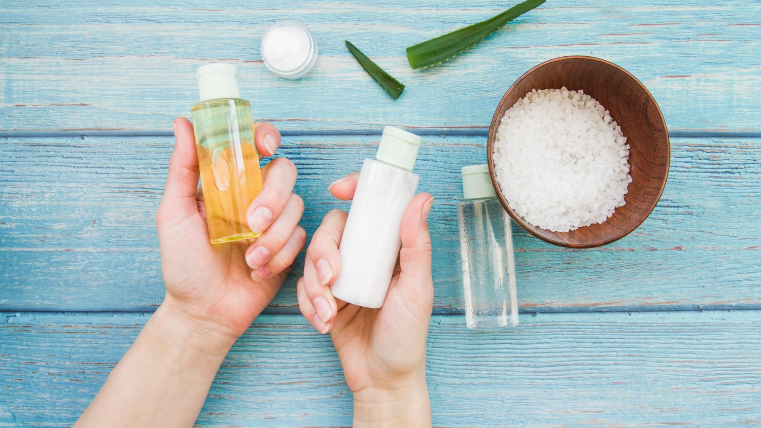 A close-up shot of hands holding a coconut oil.