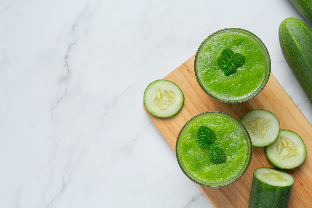 glass fresh cucumber juice marble background
